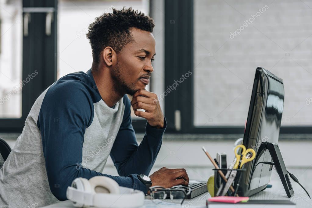 Software developer working on lotto analysis code at a desk