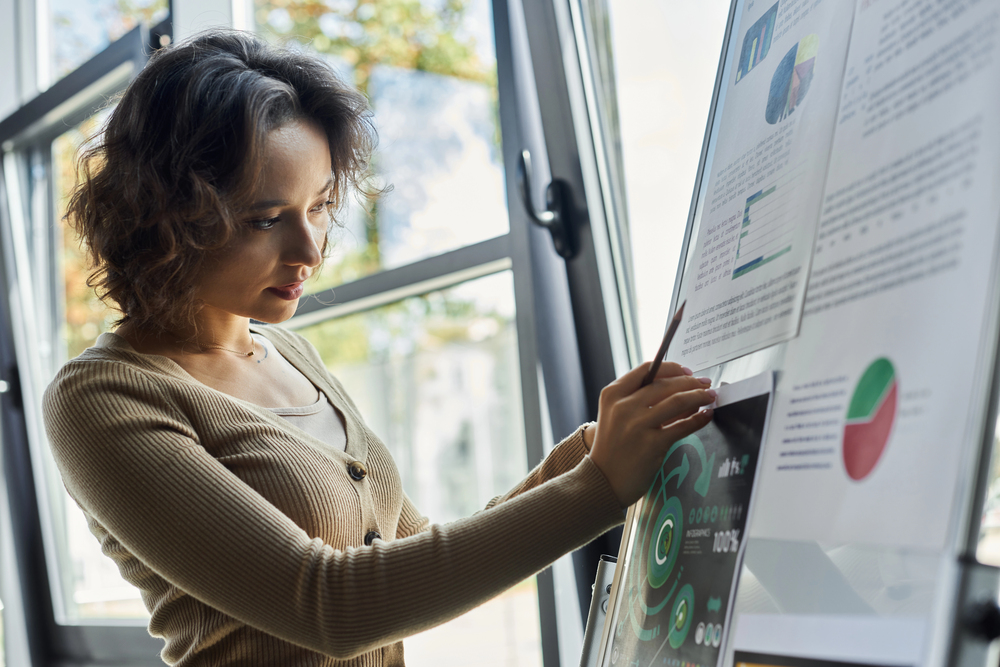 Data analyst reviewing charts and statistics on multiple screens